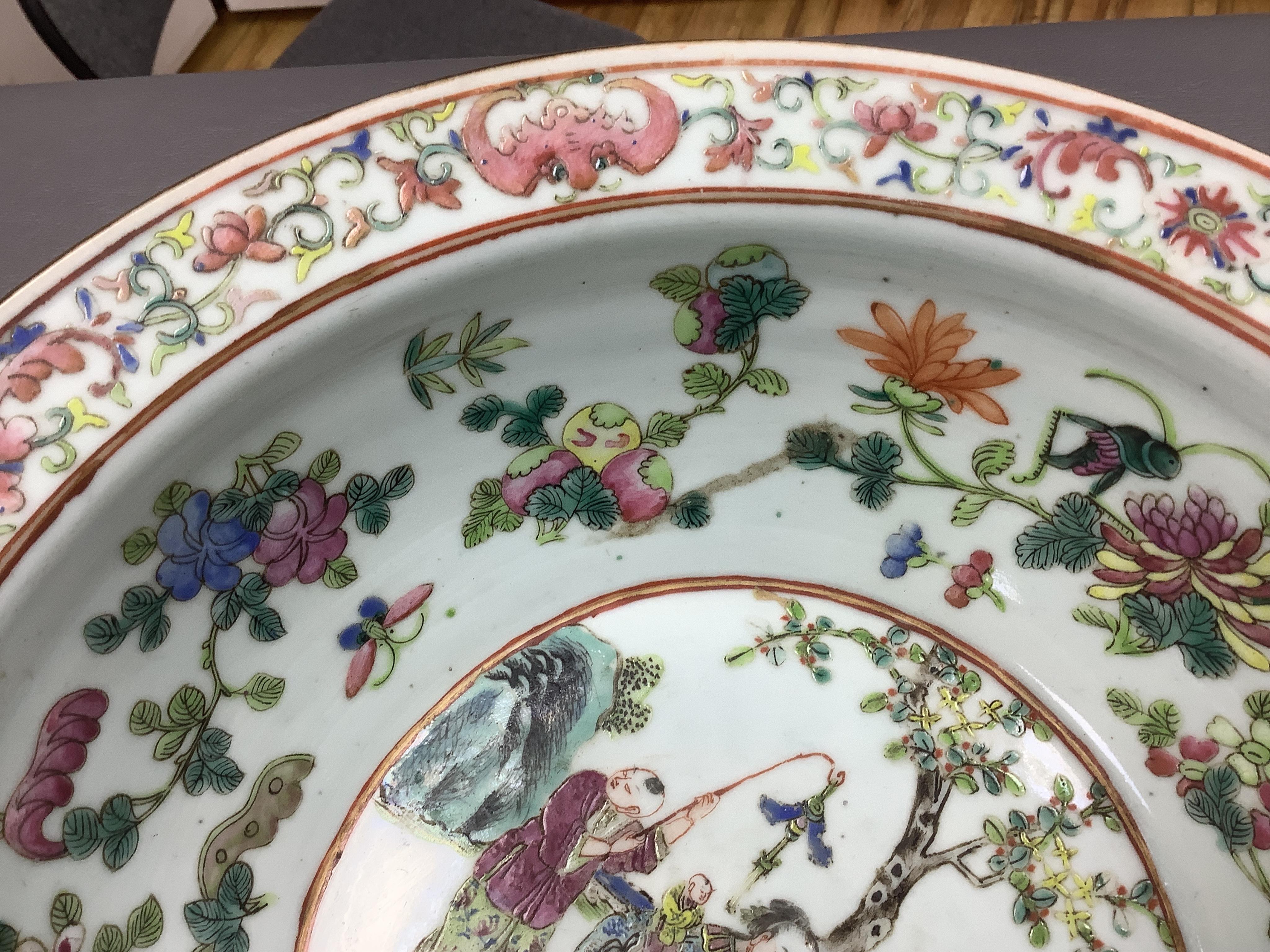 A 19th century Chinese famille rose basin, with wax seal to base., 30cm diameter x 10cm high. Condition - some wear to decoration.